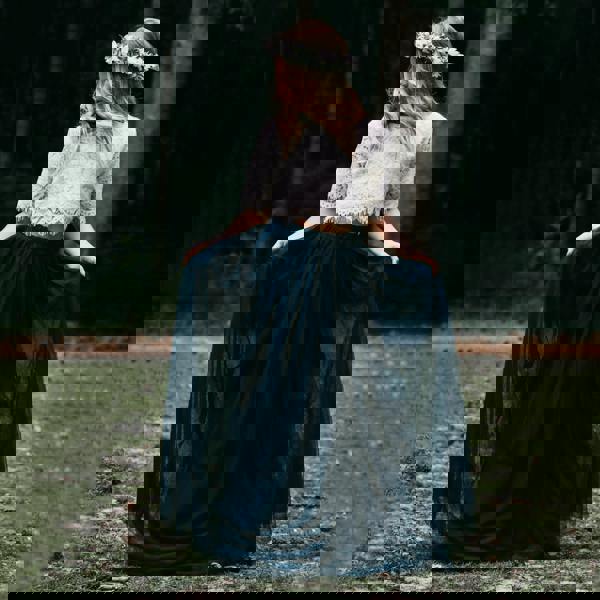 young girl holding her skirt 