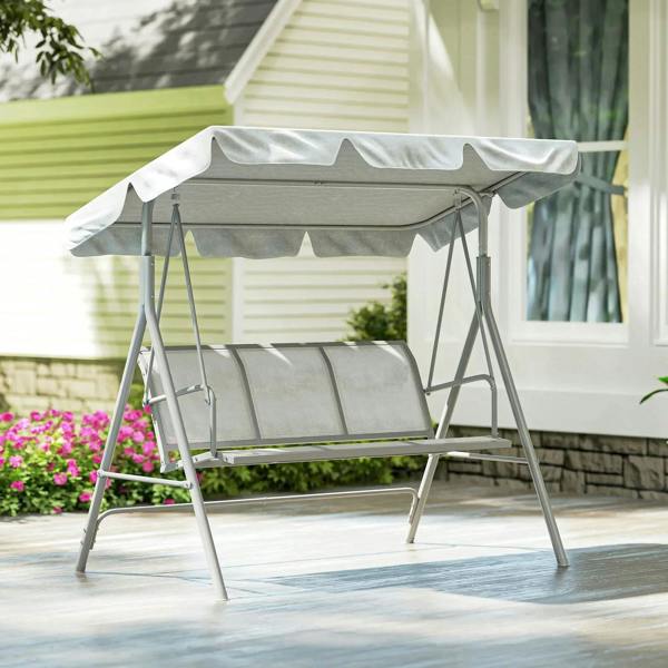 Light grey metal swing bench with canopy cover, front-right view on patio.
