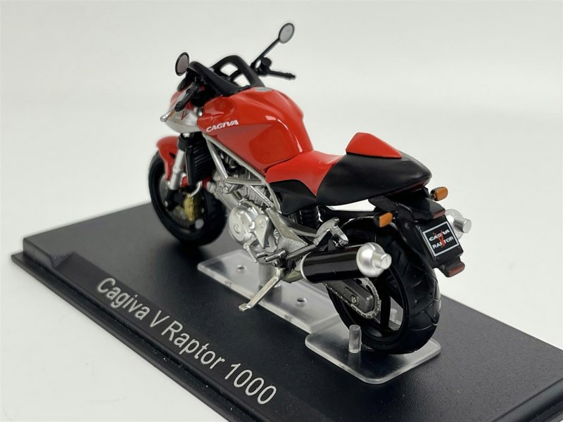 a red and black motorcycle on a black stand