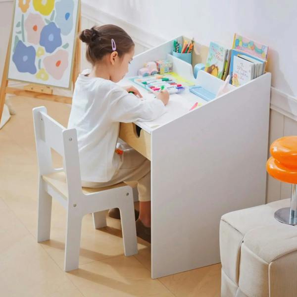 White kids desk and chair set with chair tucked under, featuring open shelf and drawer