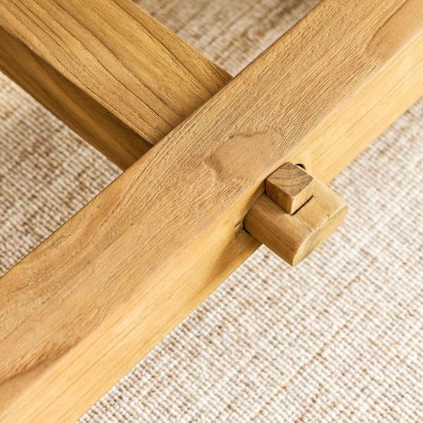 Close-up of the artisan joint detailing on the teak dining table.