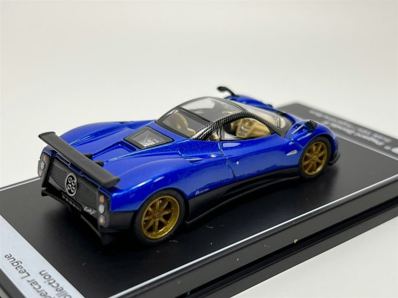 a blue toy car on a black box