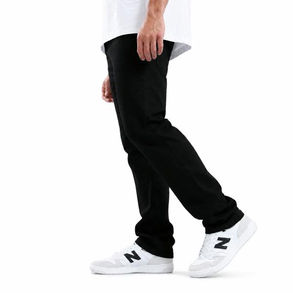 Marshall Artist black overdye denim jeans in a slim fit, styled with white and black sneakers.