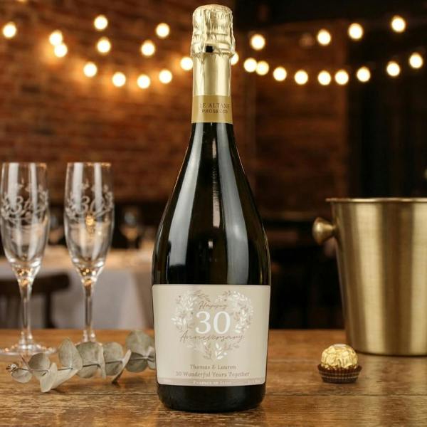 A bottle of personalised 30th Pearl Wedding Anniversary Prosecco from Abode Home & Gifts, featuring a custom pearl-toned label that reads Thomas and Lauren 30 Wonderful Years Together.