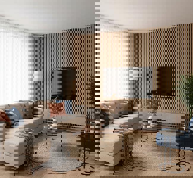 Modern living room with a beige sectional sofa, round coffee table, and acoustic slatted wall.