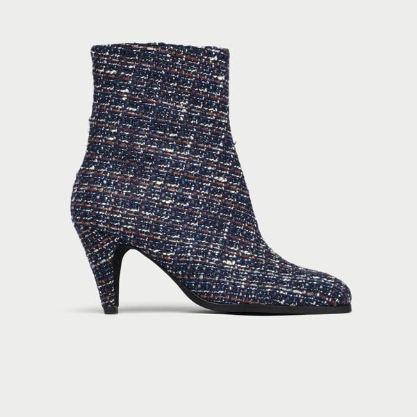 Navy blue tweed ankle boot on a light gray background