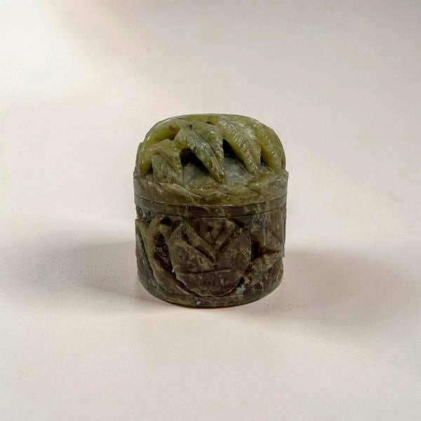 Carved stone object on a plain background