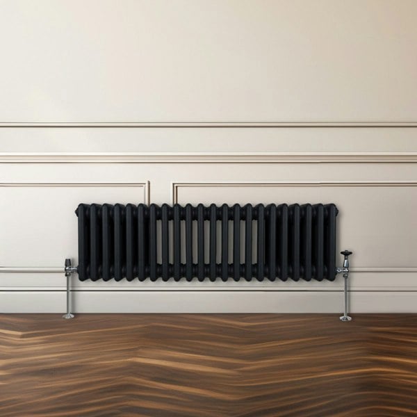 Traditional black 3 column radiator, 300 x 1012mm, featuring a sleek design with a smooth finish and stylish chrome valves against a neutral wall