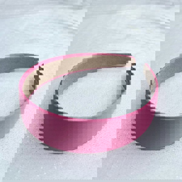 Pink hairband, smooth satin finish, soft padded design, bright pink colour, classic everyday accessory, stylish minimalist headband
