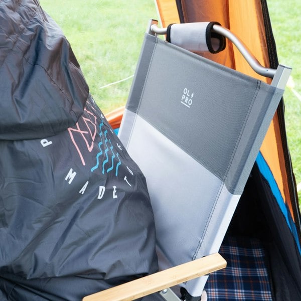 An image of the Ultralight Folding Chair from OLPRO placed inside of a camper van awning.