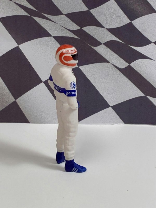 a toy figure in a race suit