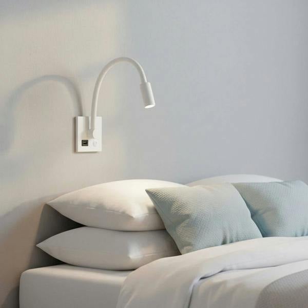 white recessed reading lamp with USB port mounted over the bed in a modern clean bedroom