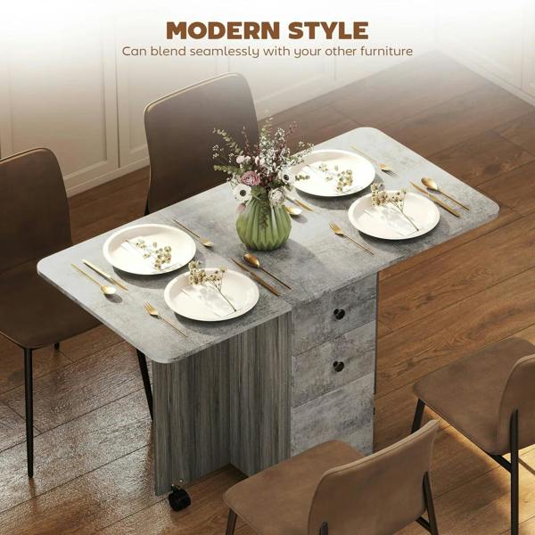 Grey drop-leaf dining table with marble-effect tabletop, three drawers, and caster feet