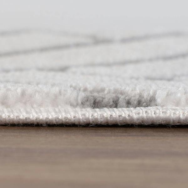 Close-up of a textured gray rug on a wooden floor