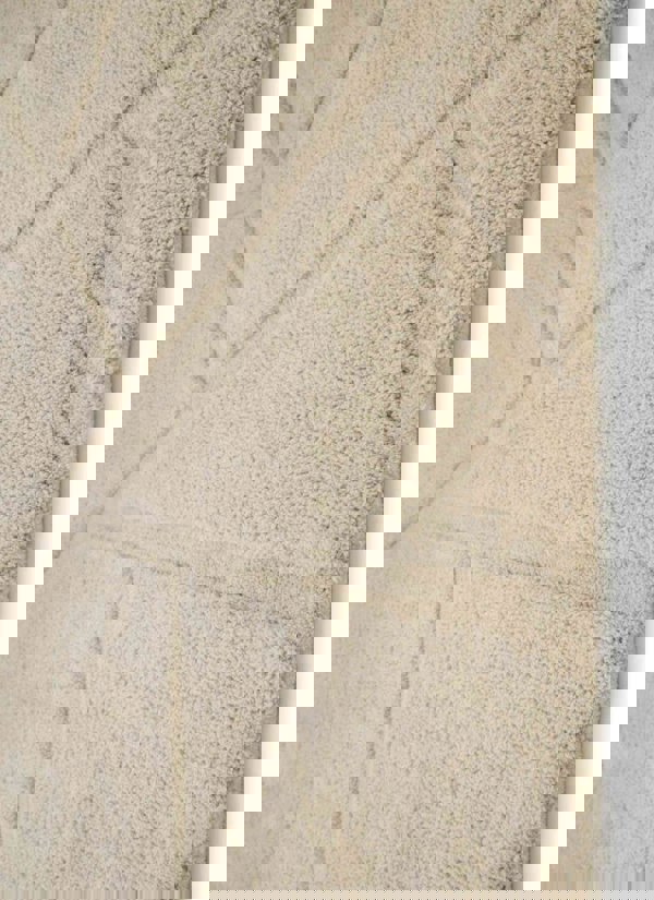 Close-up of a Scandinavian deep pile rug in cream with geometric patterns, ideal for modern and cozy interiors.