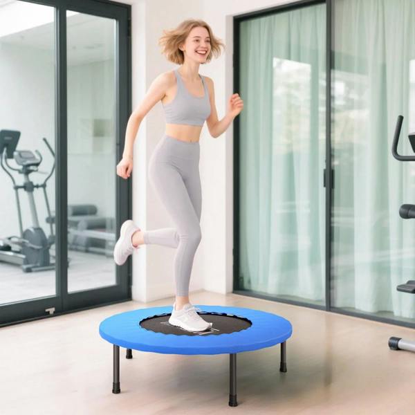 Blue mini trampoline with black center jumping mat, placed on a patio-style floor indoors