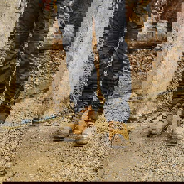 DeWalt Mentor Mens Lace Up Safety Work Steel Toe S7 Ankle Boots, yellow rugged steel toe work boots worn in muddy construction site.