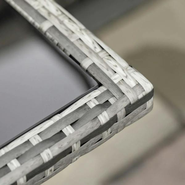 Close-up of woven rattan tabletop frame edge with grey and white basket weave