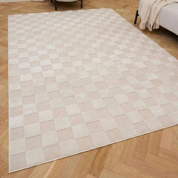 Beige checkered rug on a wooden floor