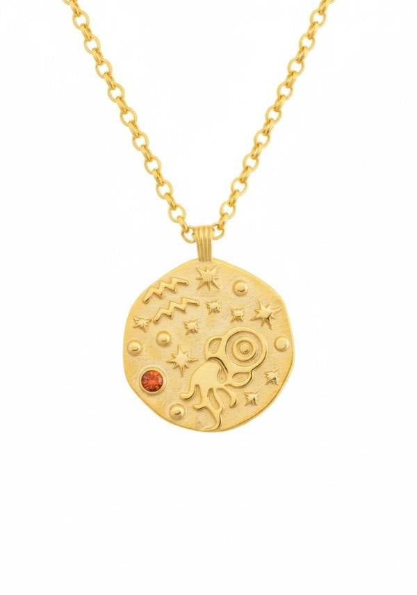 Gold necklace with a celestial pendant on a white background