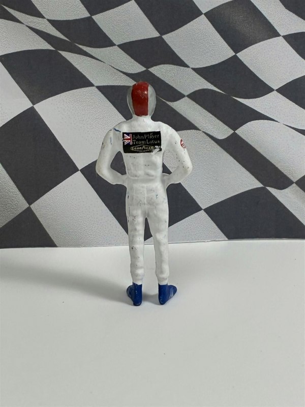 a toy figure of a man in a white suit