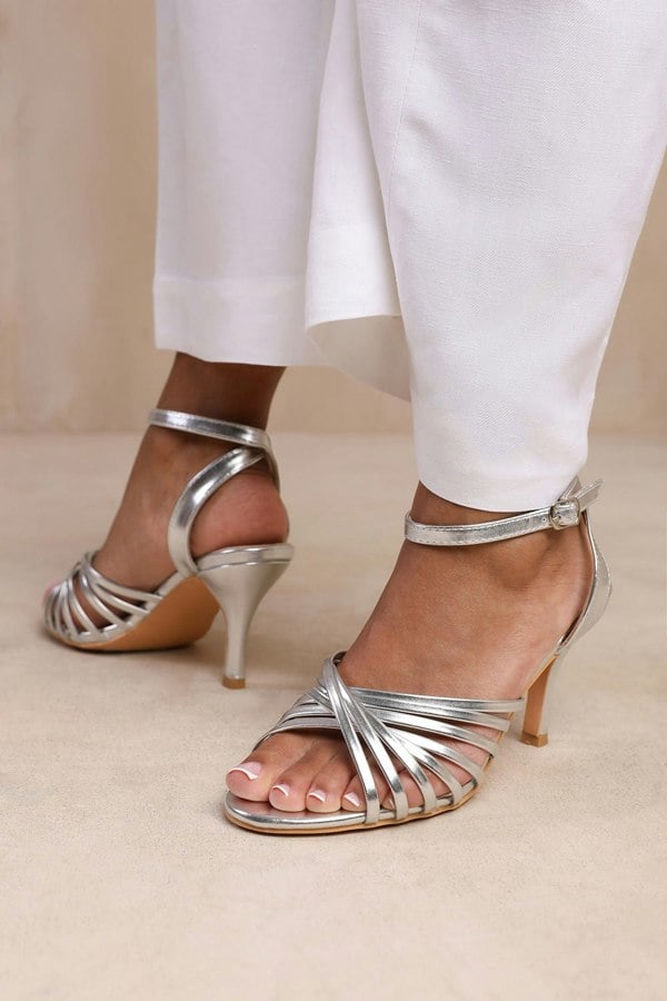 Where's That From Cyprus Wide Fit Multi Cross Over Strap Mid Heels in Silver Faux Leather