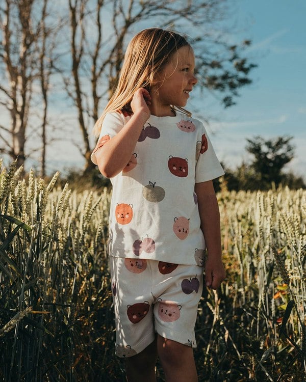 Girl wearing gender-neutral kids t-shirt and shorts set