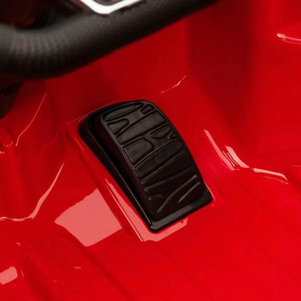 Red electric ride-on car textured foot pedal on the side