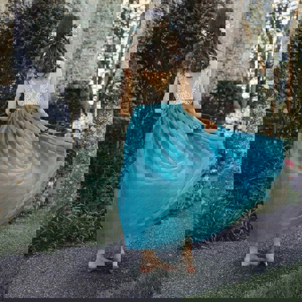 young girl wearing a teal flower girl dress