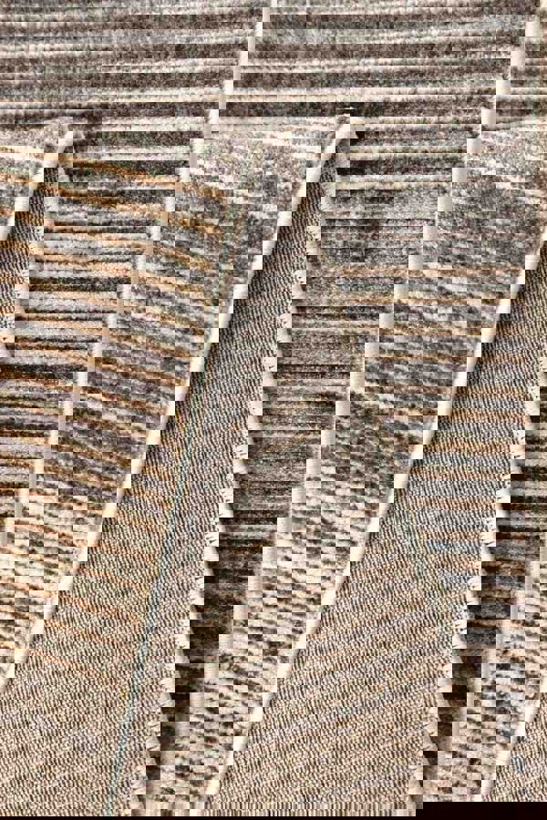 Aspre Shades Lines Rug showcasing rich brown stripes and high-low texture, perfect for modern interiors.