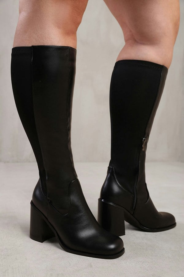 Where's That From Zhuri Stretch Wide Calf Block Heel Knee High Boots In Wide E Fit In Black Faux Leather