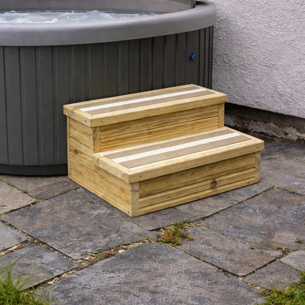Two-step treated timber decking steps beside outdoor hot tub with white anti-slip strips