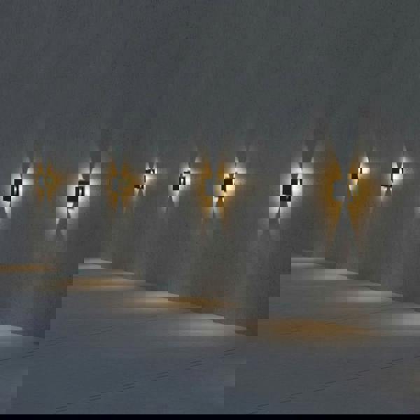 black outdoor step light mounted along an exterior wall in a row