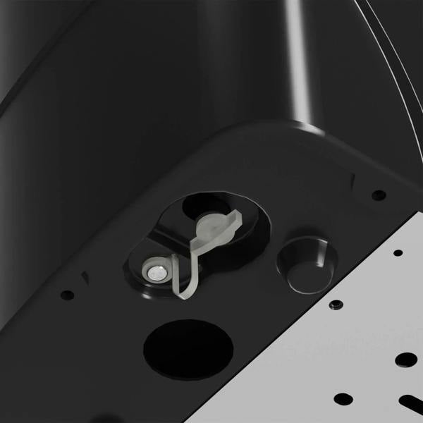 Black ice cube machine internal component close-up on light base panel