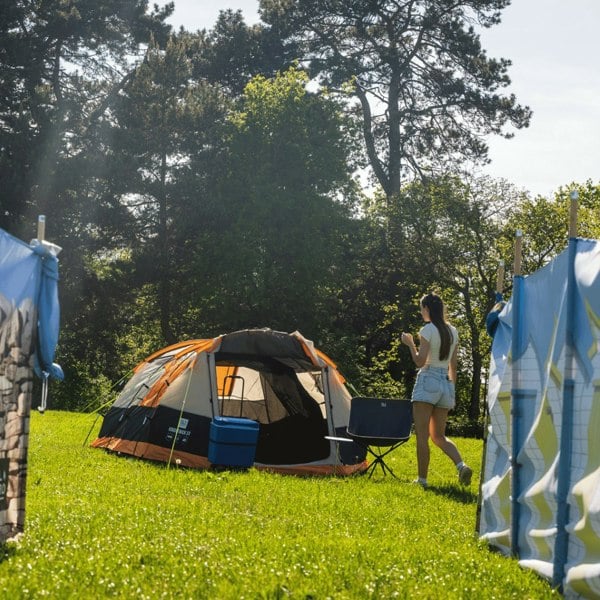 Knightwick 3.0 3 berth tent setup in a campsite between two OLPRO windbreaks