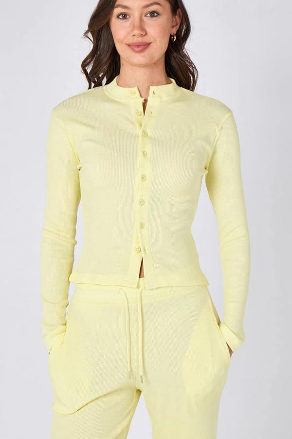 Woman wearing a light yellow outfit on a white background