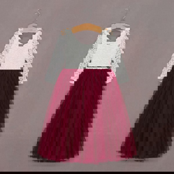 White lace top and red tulle skirt dress on a hanger against a gray background