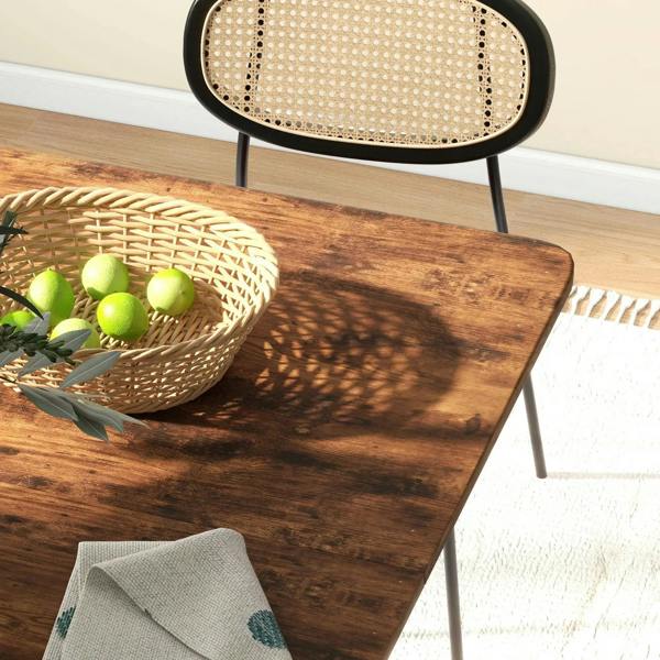 Rustic brown tabletop with visible wood grain next to a curved black chair back