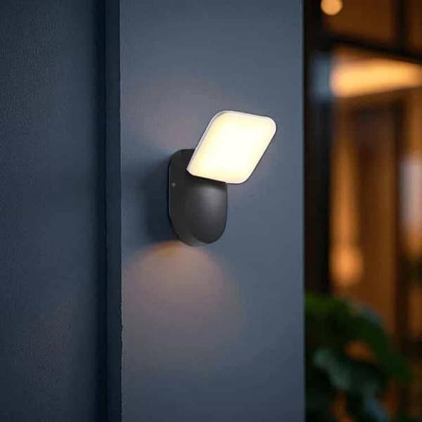 black external wall lamp mounted on a grey external wall 