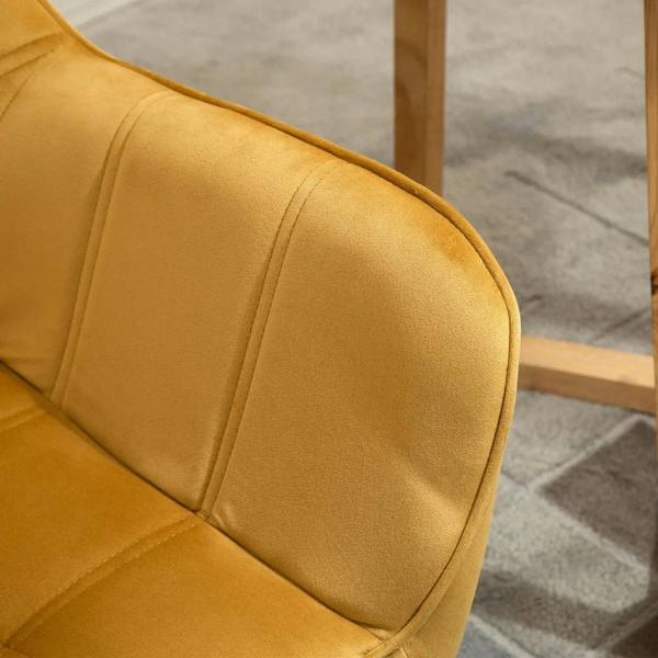 Yellow upholstered armrest and seat corner with quilted stitching and curved back