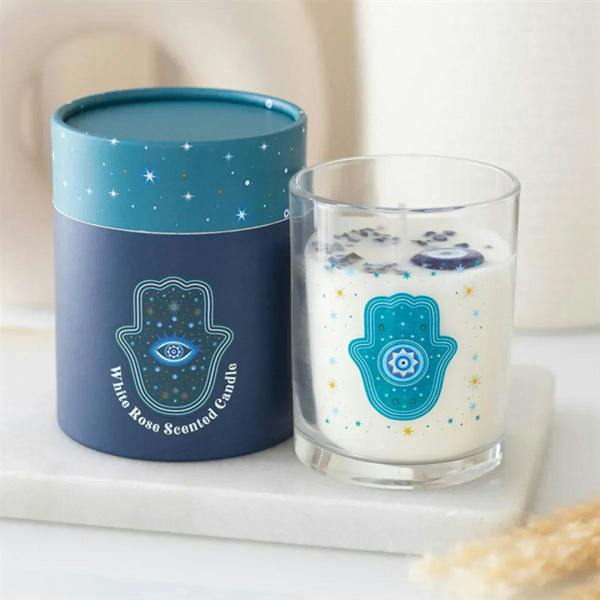 Teal starry candles: blue jar candle and clear glass candle with teal hamsa eye emblem