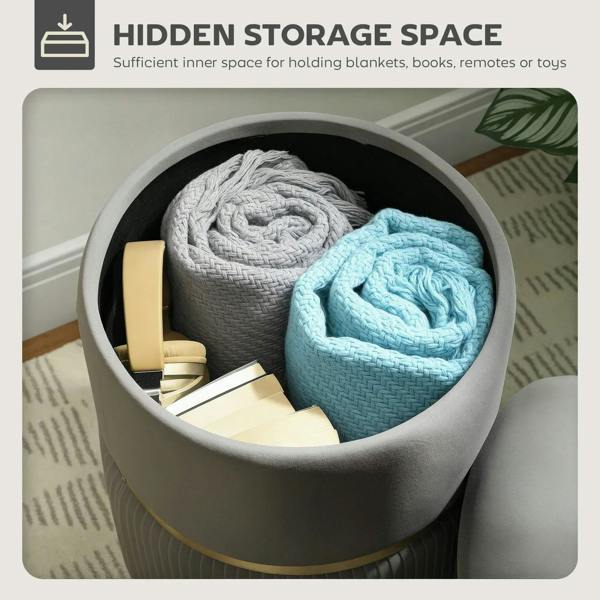 Grey storage ottoman with open lid revealing blankets in hidden storage space