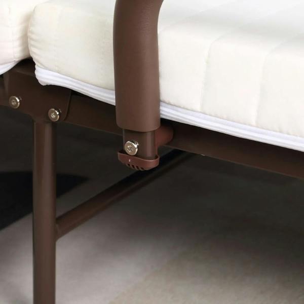 Detail of brown metal folding bed leg and caster wheel with locking foot