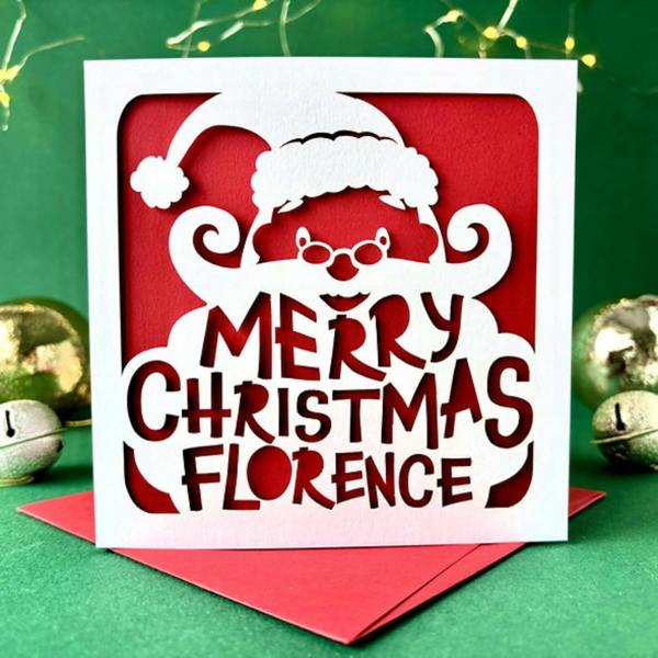 Personalised Santa's beard papercut Christmas card reading Merry Christmas Florence on red insert