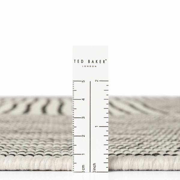 Textured rug with a ruler for scale and 'Ted Baker London' branding.