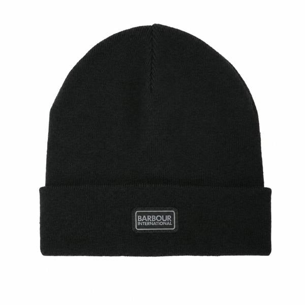 Black knitted Barbour International beanie with a cuffed brim and a rectangular gunmetal logo patch on the front.