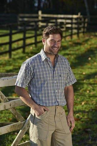 Man in open field wearing Champion Doncaster green check shirt – lightweight and breathable