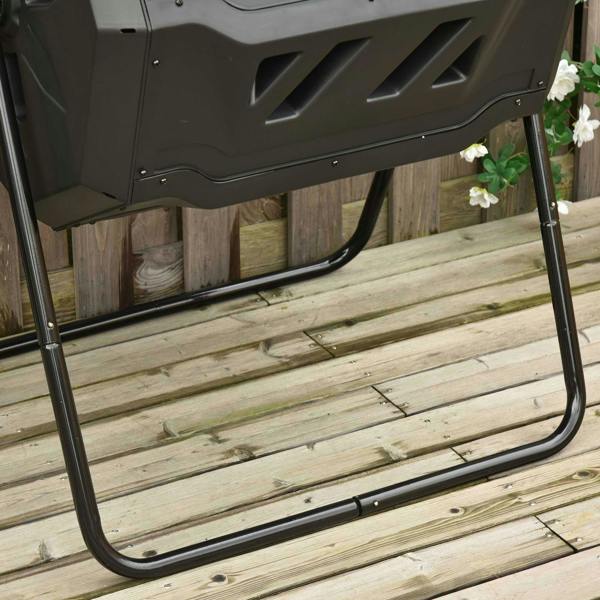Black dual-chamber composter base frame with curved legs on wooden deck