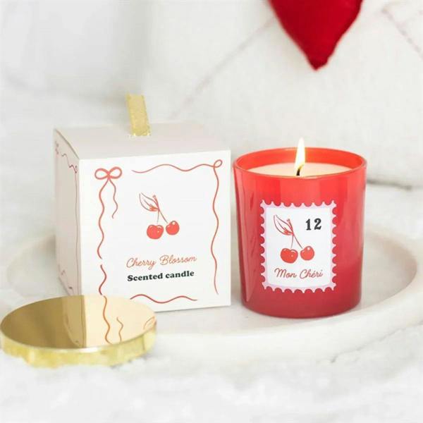 Cherry Blossom scented candle in red glass jar with gold lid and '12' label