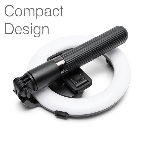 The Rio GlamourGlow Pro Beauty & Vlogging Ring Light features a black handheld device with a ribbed grip resting on its white circular light, perfect for vlogging. “Compact Design” is displayed in the top left corner.